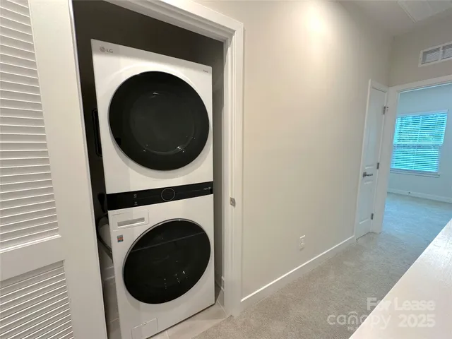 a view of a hallway with washer and dryer