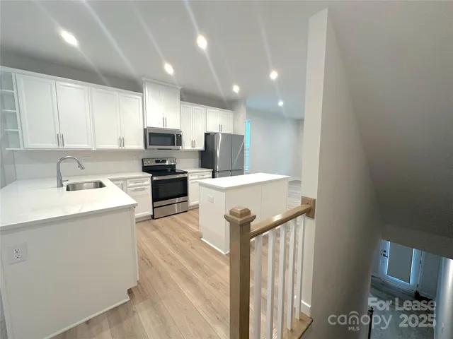a kitchen with a sink stainless steel appliances and cabinets