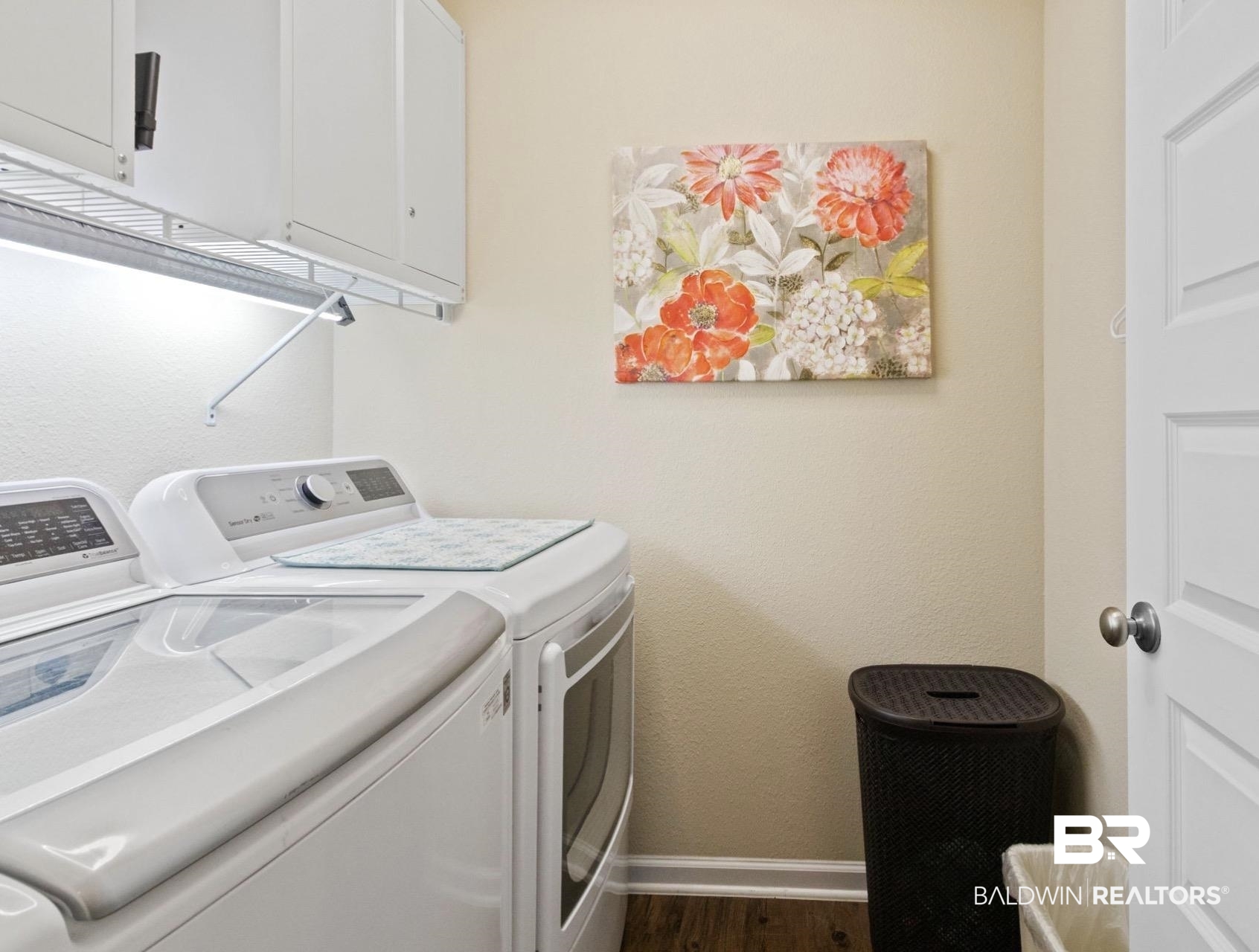1676 Abbey Loop Foley, AL 36535 - Photo 20 of 31 Dedicated laundry area featuring white upper cabinetry, wire shelving, and wood-finish flooring