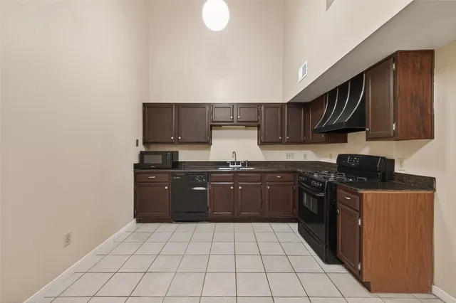 a kitchen with stainless steel appliances granite countertop a sink and cabinets