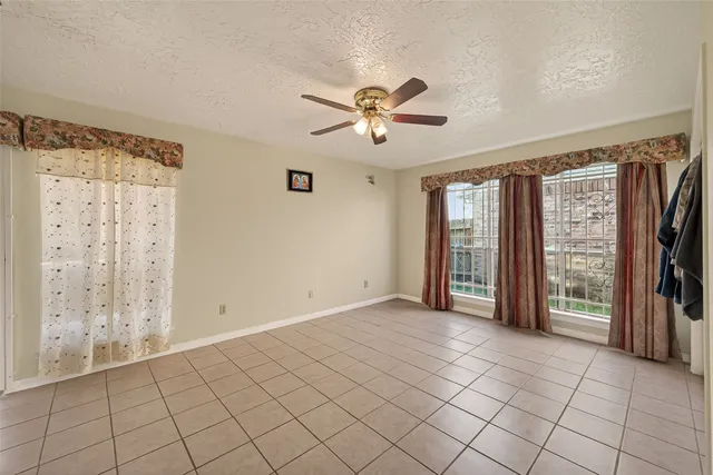 a bathroom with a granite countertop sink a toilet a mirror and shower