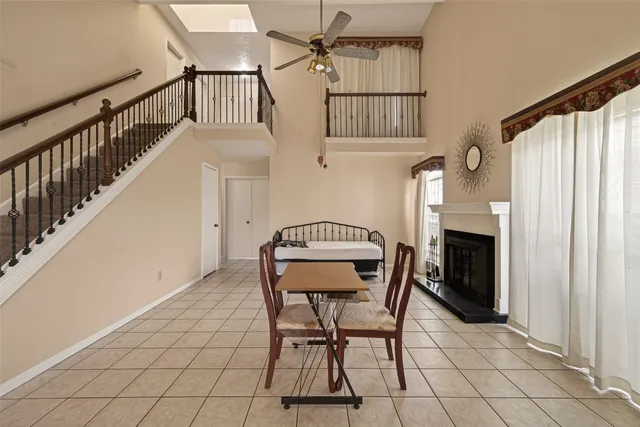 a view of a livingroom with a ceiling fan and window