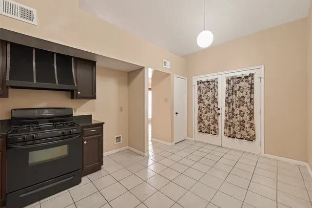 a stove top oven sitting inside of a kitchen