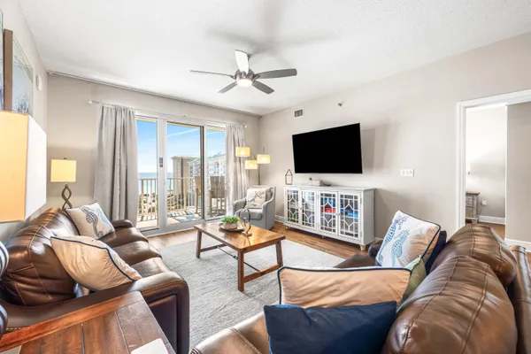 a kitchen with stainless steel appliances granite countertop a stove top oven a sink dishwasher a dining table and chairs with wooden floor