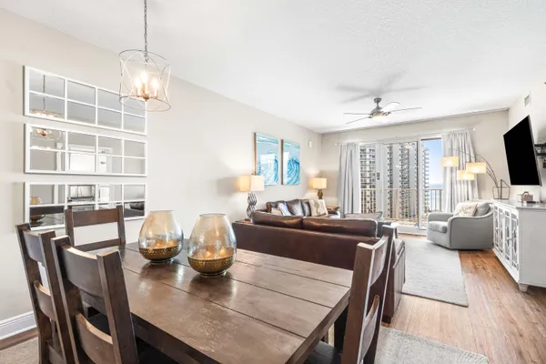 a kitchen with stainless steel appliances granite countertop a refrigerator a sink a stove with white cabinets