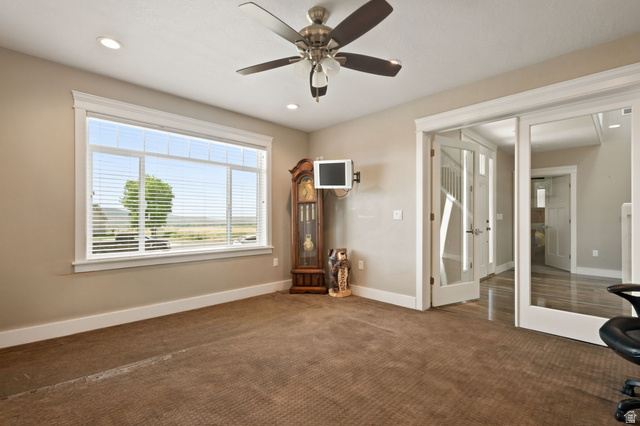 580 North 300 East Logan, UT 84321 - Photo 25 of 74 Carpeted room featuring a multi-pane window, white baseboards, and neutral wall tones