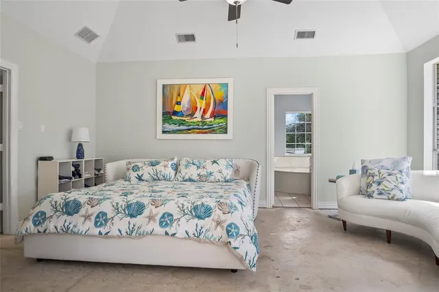 a bedroom with a bed and glass window