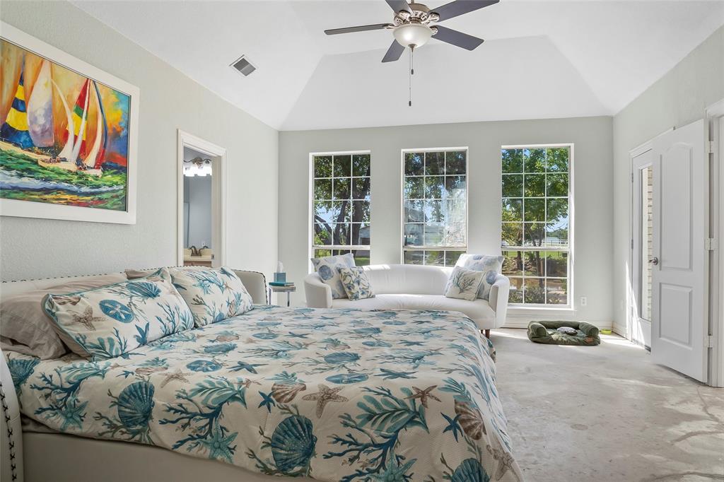 1082 Post Oak Road Copper Canyon, TX 76226 - Photo 16 of 40 a bedroom with a bed and glass window