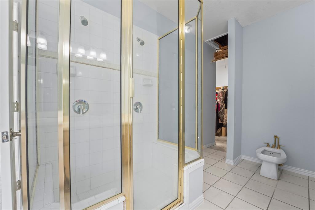1082 Post Oak Road Copper Canyon, TX 76226 - Photo 19 of 40 a bathroom with a granite countertop toilet and a shower