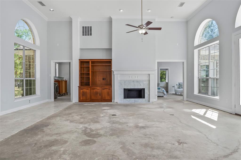 1082 Post Oak Road Copper Canyon, TX 76226 - Photo 6 of 40 a view of an empty room with a fireplace and a window