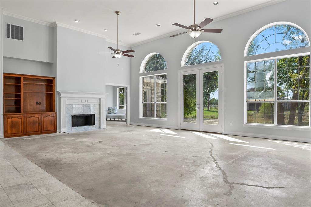1082 Post Oak Road Copper Canyon, TX 76226 - Photo 8 of 40 a view of an room with chandelier fan and fireplace