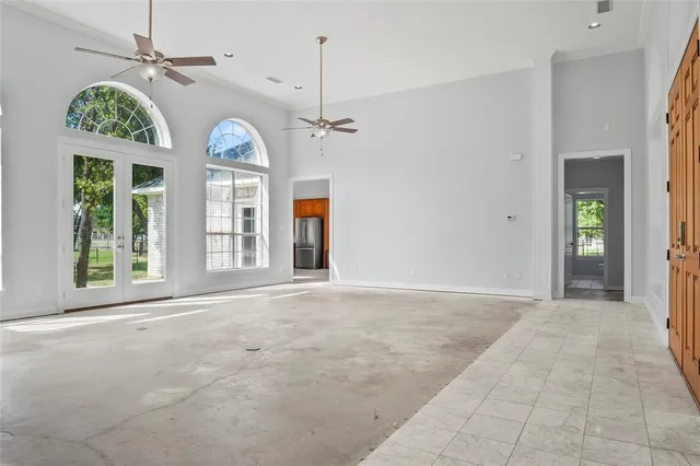 a large kitchen with stainless steel appliances granite countertop a refrigerator a sink a stove a washer and dryer with wooden floor