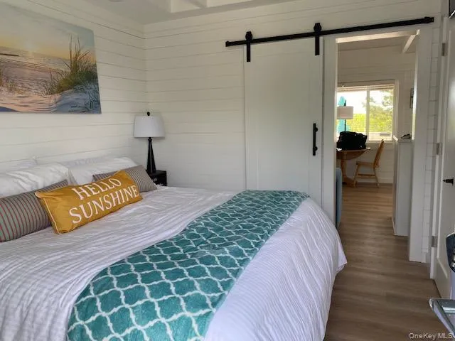 a bedroom with a bed and a mirror