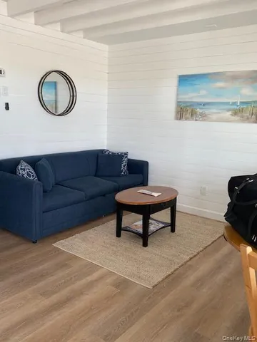 a living room with furniture a rug and a wall painting