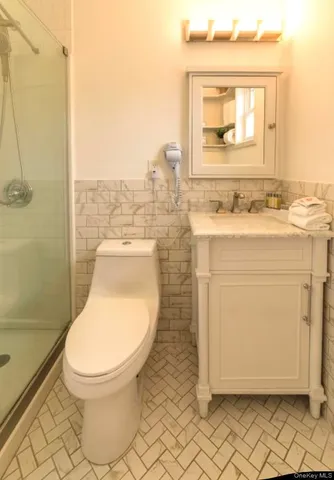 a bathroom with a toilet a sink and mirror