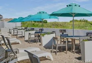 a view of an outdoor space with furniture and umbrella