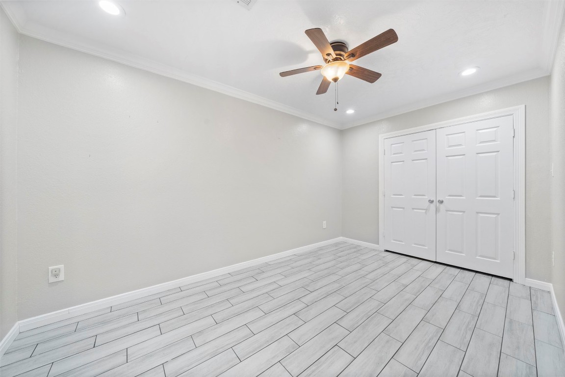 7941 Goode Street Houston, TX 77012 - Photo 13 of 26 an empty room with wooden floor and ceiling fan