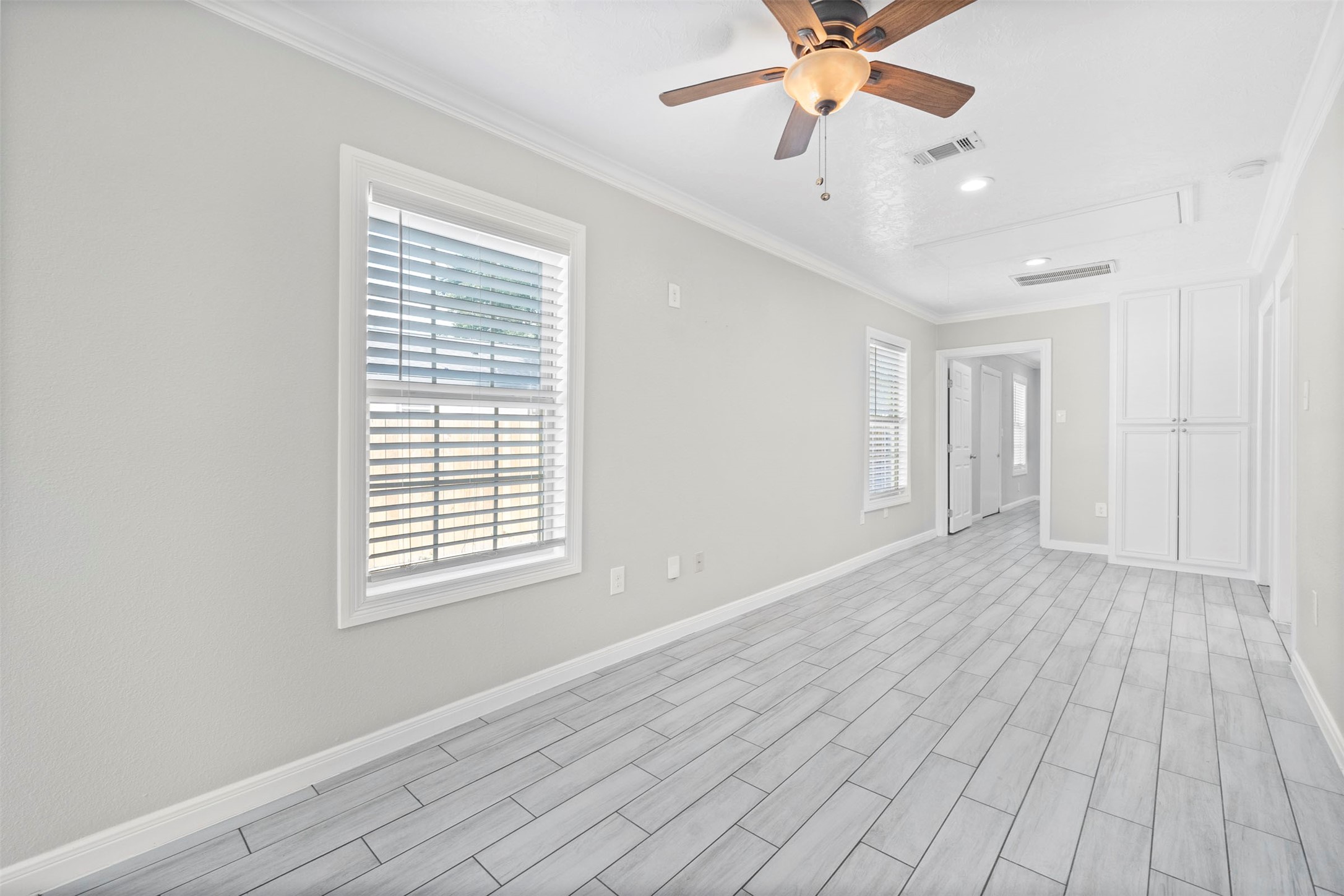 7941 Goode Street Houston, TX 77012 - Photo 16 of 26 a view of an empty room with wooden floor and a window