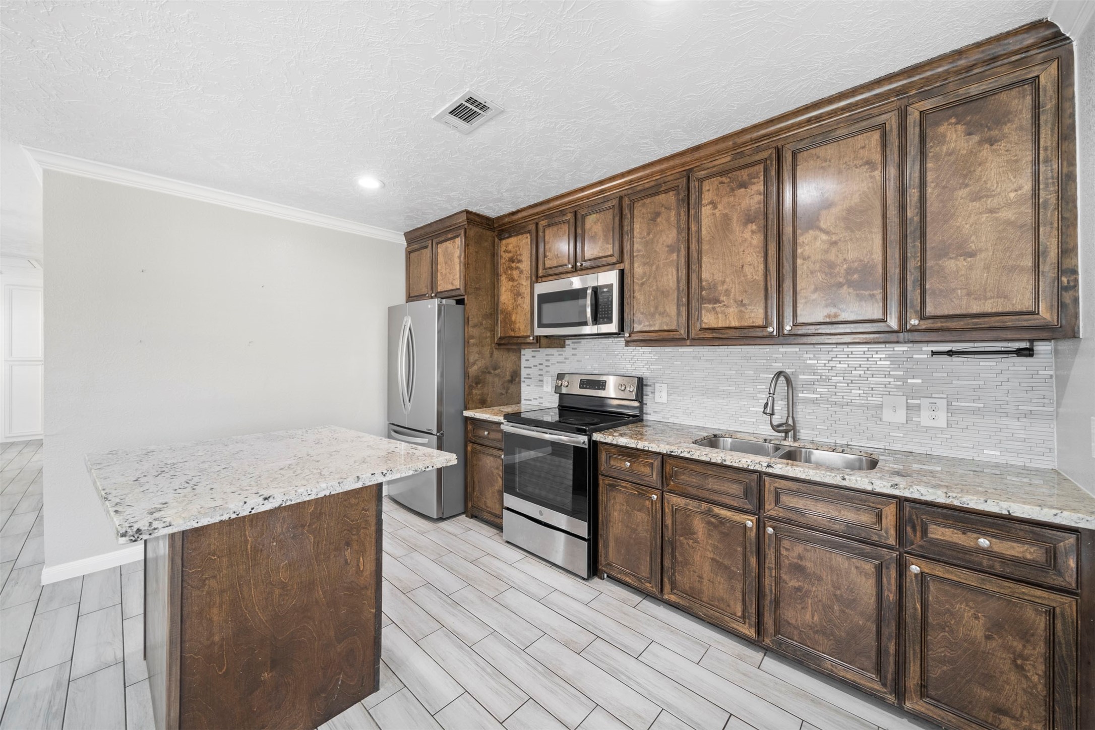 7941 Goode Street Houston, TX 77012 - Photo 20 of 26 a kitchen with stainless steel appliances granite countertop a sink stove and refrigerator