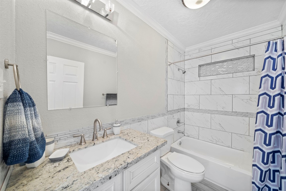 7941 Goode Street Houston, TX 77012 - Photo 24 of 26 a bathroom with a granite countertop sink toilet and shower