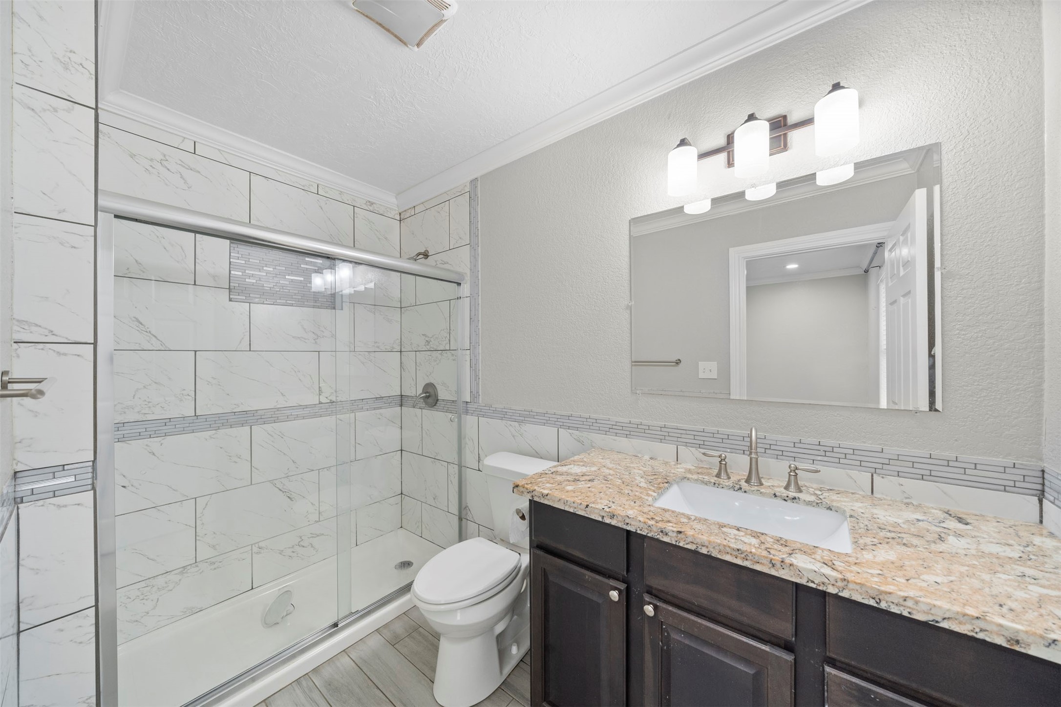 7941 Goode Street Houston, TX 77012 - Photo 8 of 26 a bathroom with a granite countertop sink toilet and shower