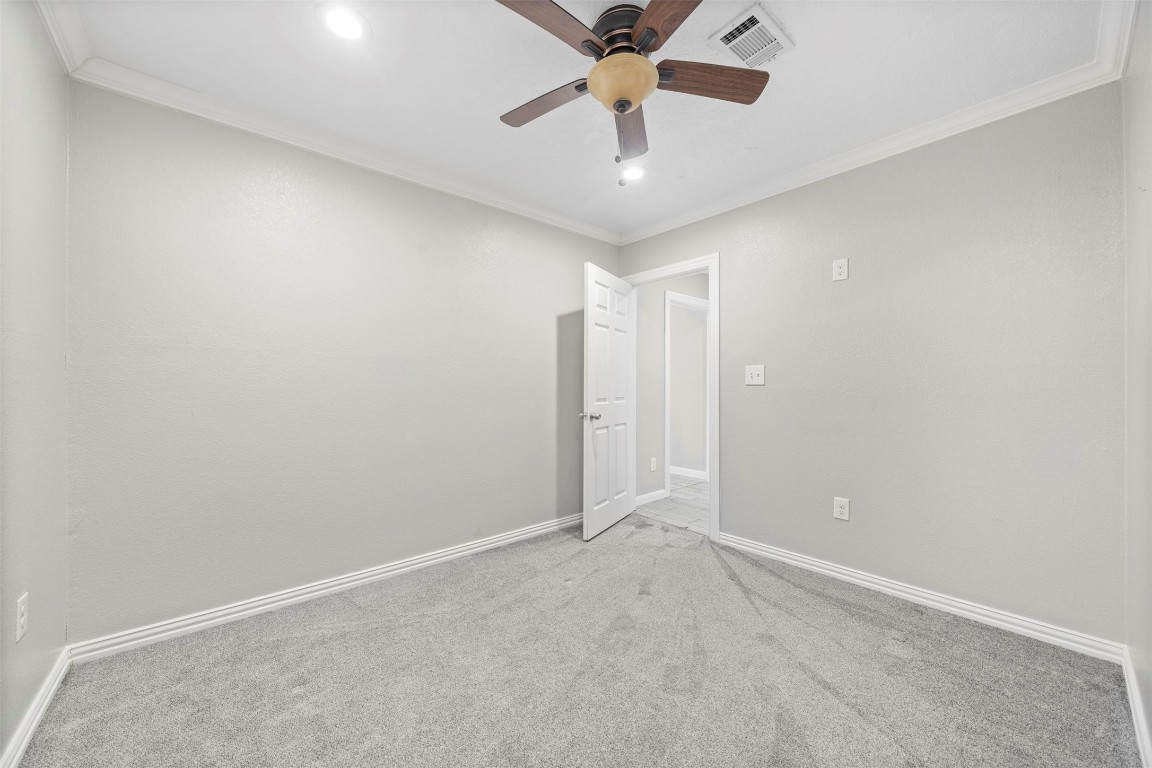 7941 Goode Street Houston, TX 77012 - Photo 10 of 26 an empty room with a chandelier fan and a ceiling fan