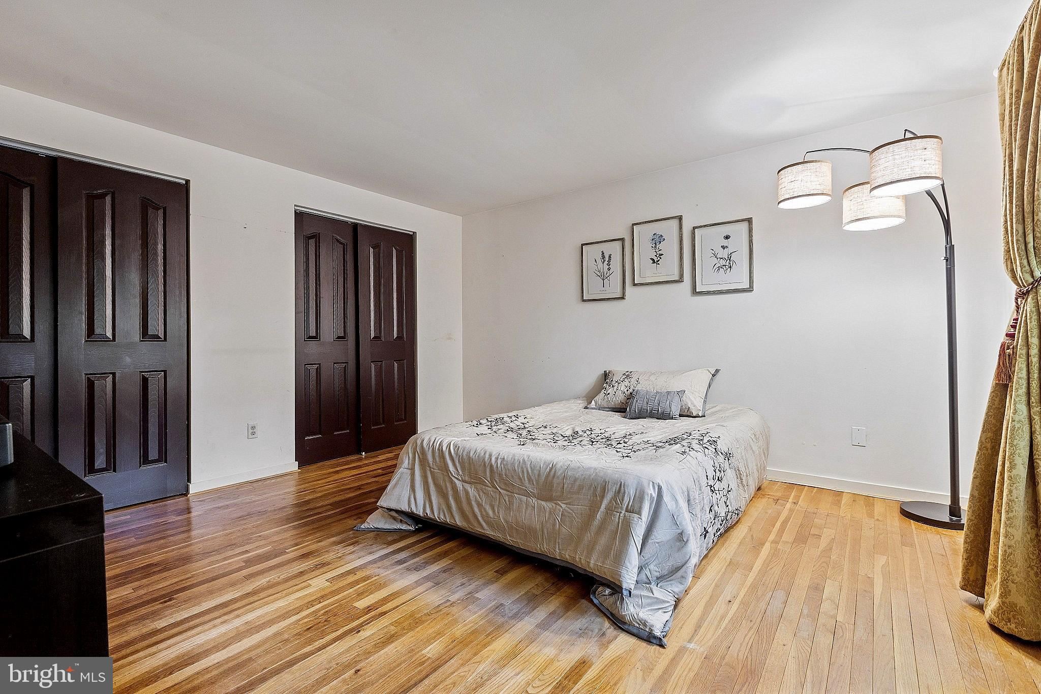 5210 Windmill Lane Columbia, MD 21044 - Photo 18 of 29 a bedroom with a bed and wooden floor