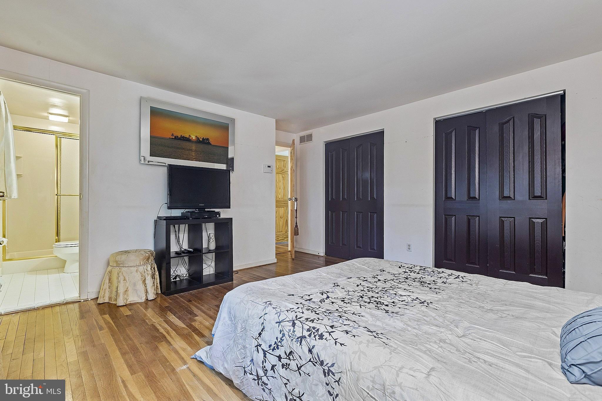 5210 Windmill Lane Columbia, MD 21044 - Photo 19 of 29 a bedroom with a bed and a wooden floor
