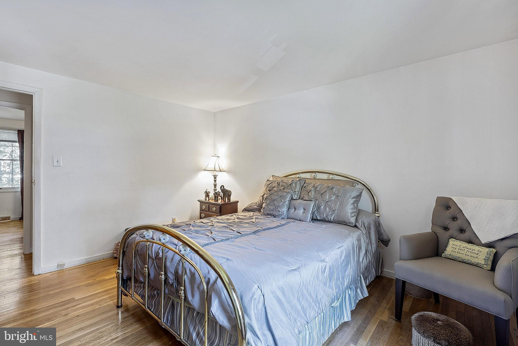 5210 Windmill Lane Columbia, MD 21044 - Photo 25 of 29 a bedroom with a bed and wooden floor