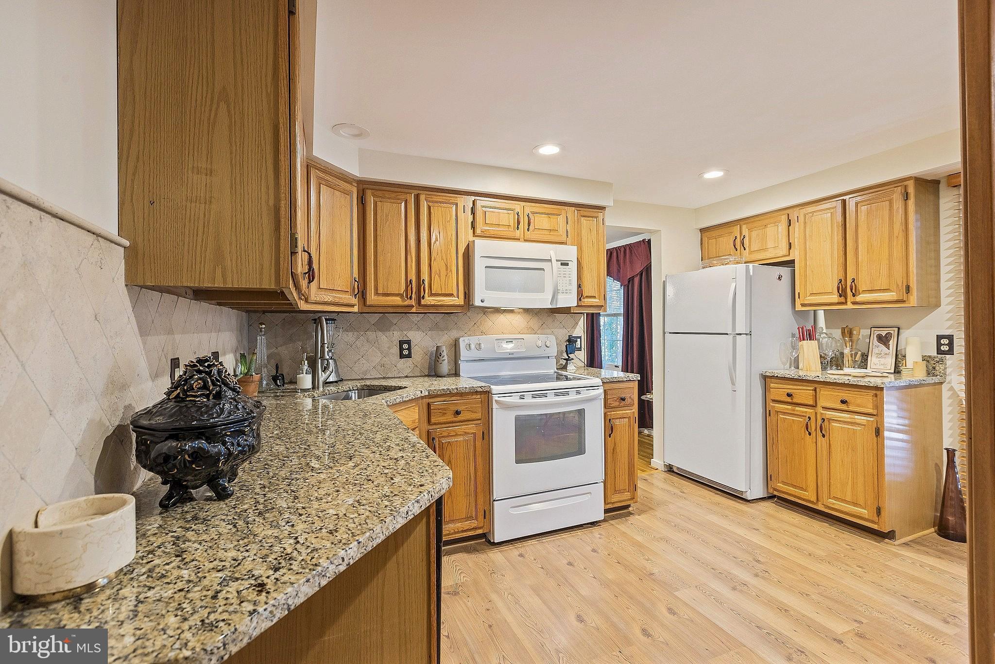 5210 Windmill Lane Columbia, MD 21044 - Photo 5 of 29 a kitchen with a refrigerator stove top oven and sink