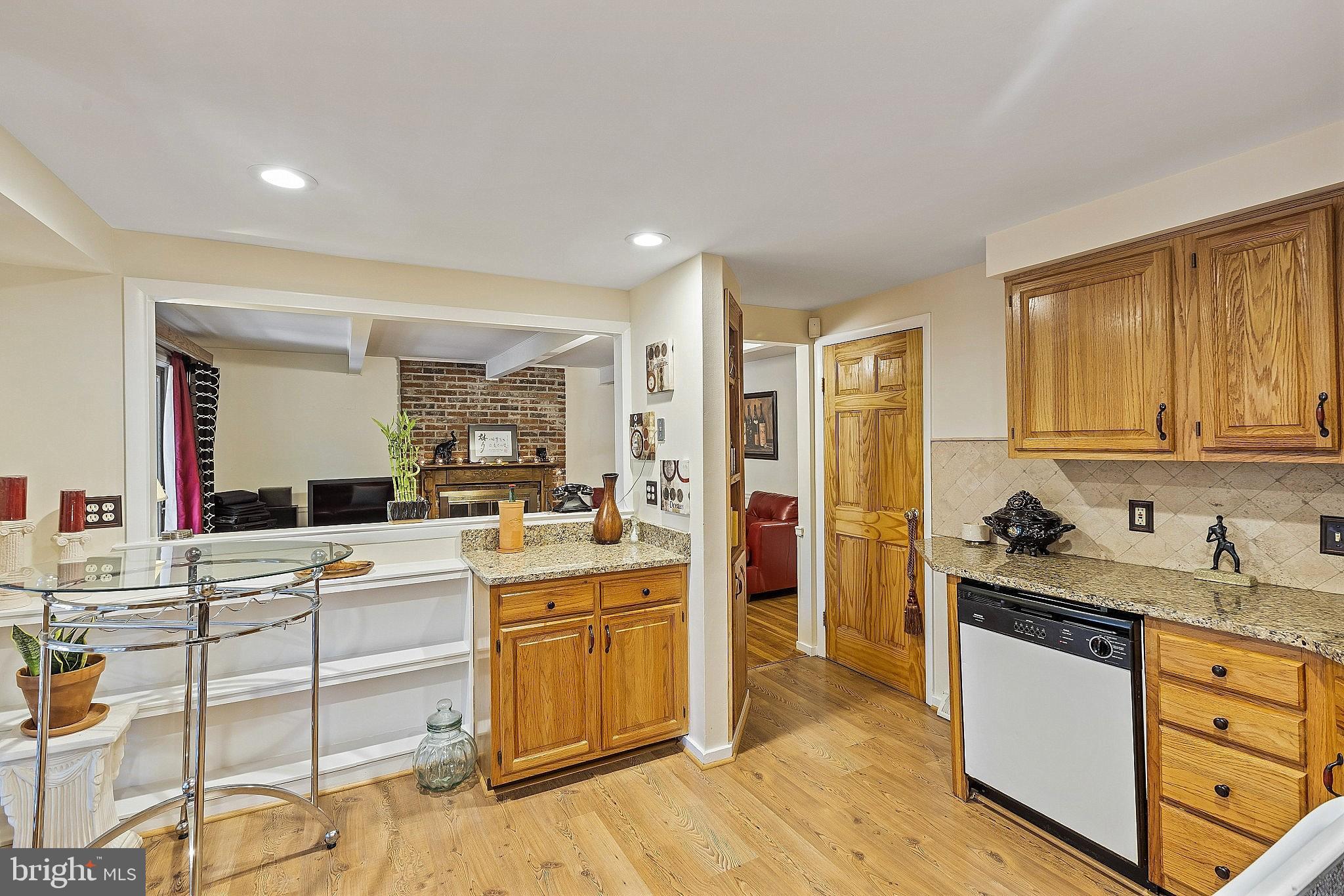 5210 Windmill Lane Columbia, MD 21044 - Photo 8 of 29 a kitchen with stainless steel appliances kitchen island granite countertop a sink and cabinets