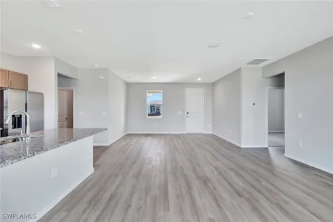 a view of a kitchen cabinets a sink and wooden floor