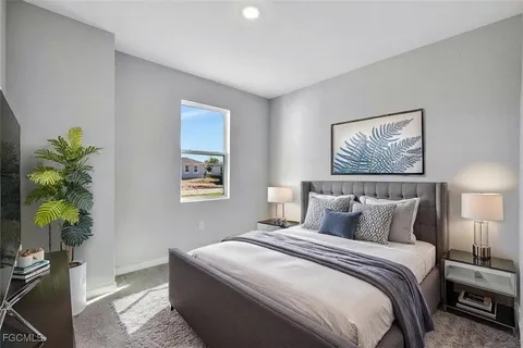 a bedroom with bed and a potted plant
