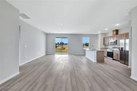 a view of kitchen with wooden floor and electronic appliances