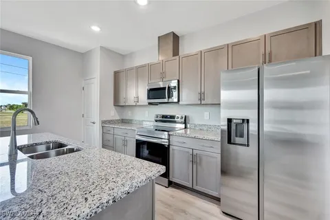 a kitchen with a sink stove and refrigerator