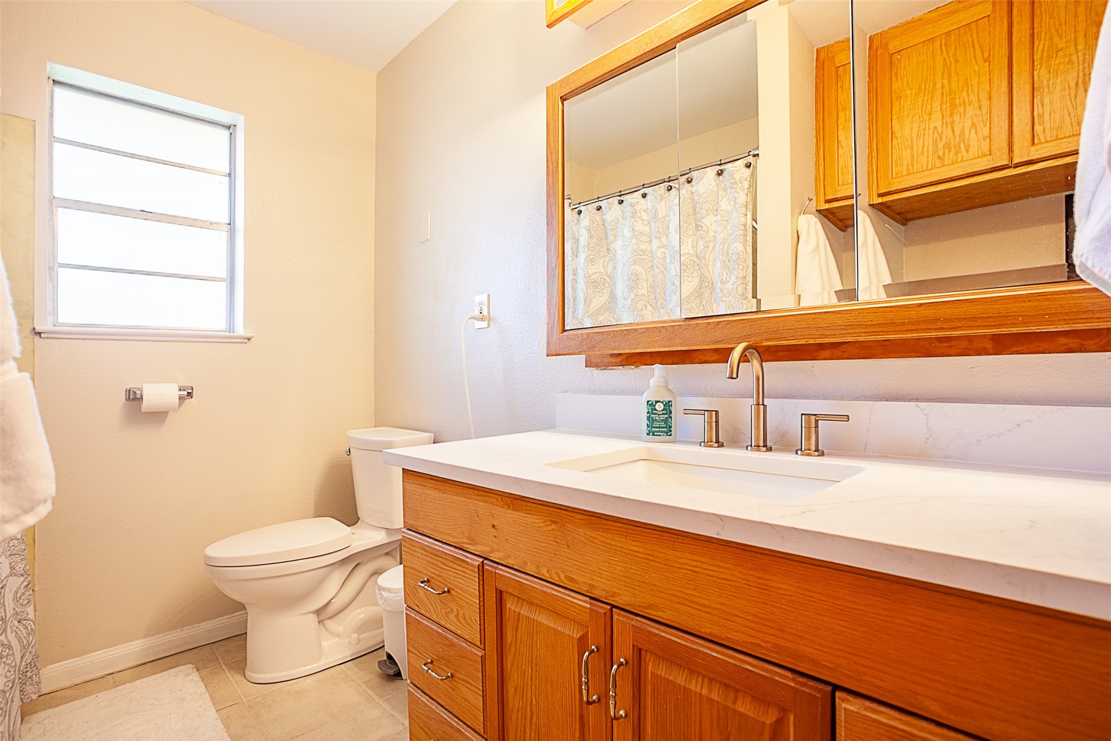 3381 Carpenter Road Orange, TX 77630 - Photo 17 of 29 a bathroom with a granite countertop sink toilet and mirror