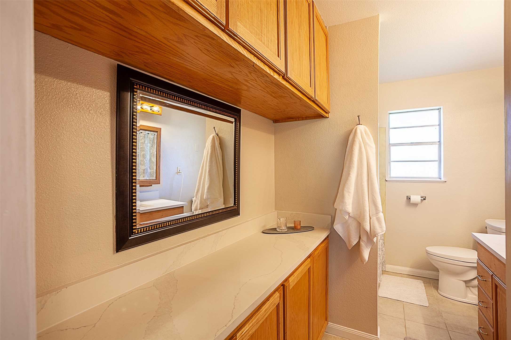 3381 Carpenter Road Orange, TX 77630 - Photo 18 of 29 a bathroom with a granite countertop sink toilet and shower