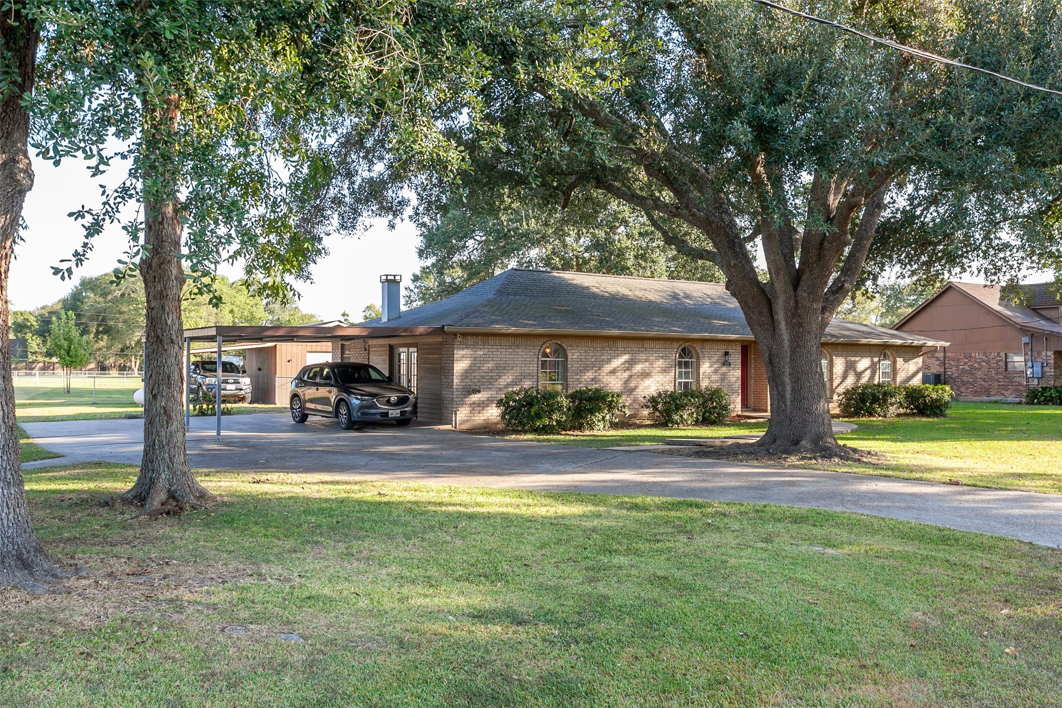 3381 Carpenter Road Orange, TX 77630 - Photo 29 of 29 a view of a big house with large trees and a big yard with large trees