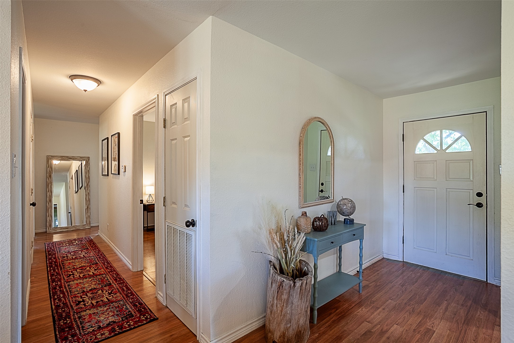 3381 Carpenter Road Orange, TX 77630 - Photo 3 of 29 a view of a hallway to a livingroom with wooden floor and furniture
