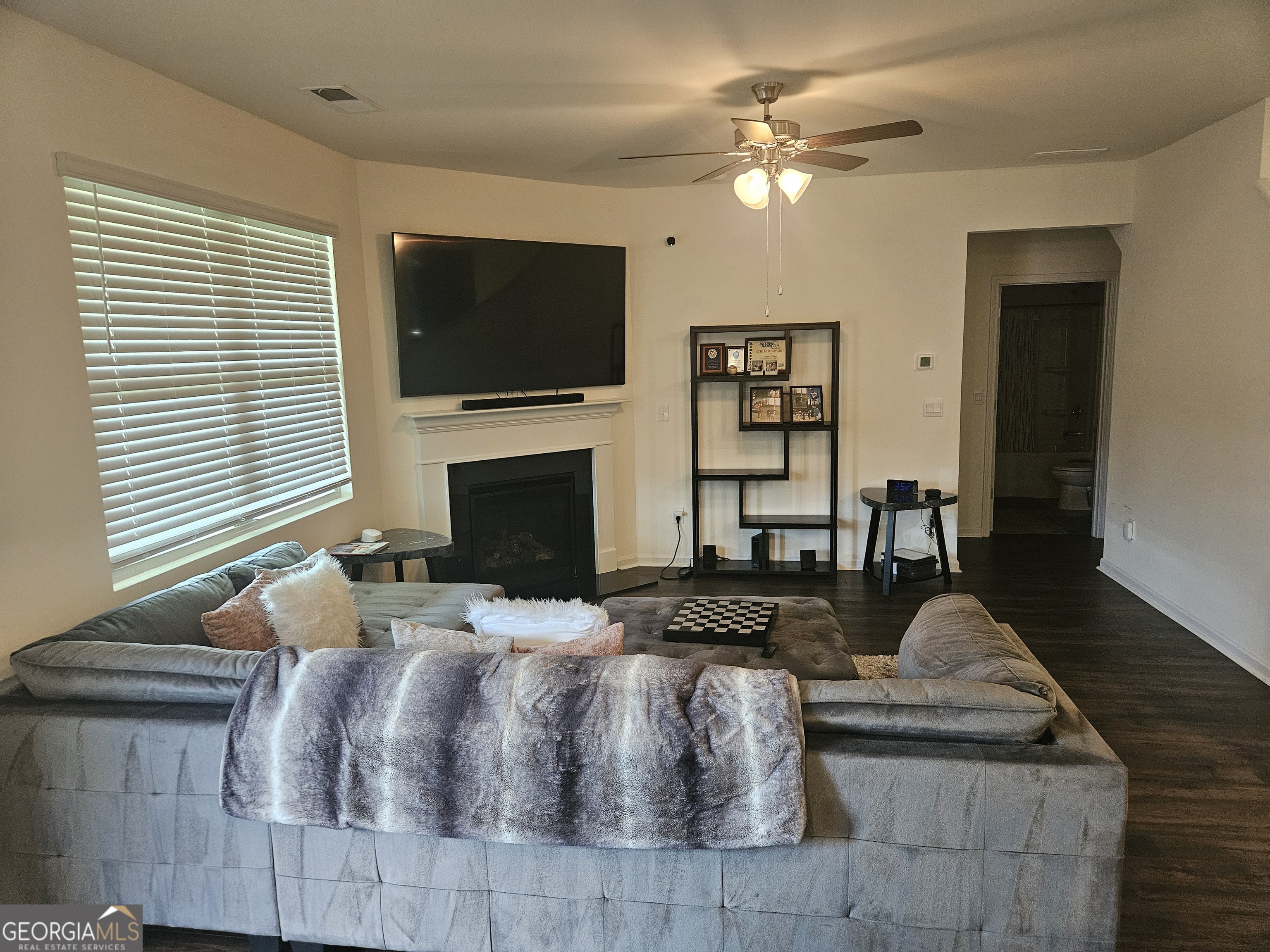 5454 Flat Rock Point Lithonia, GA 30038 - Photo 11 of 24 a living room with furniture a flat screen tv and a fireplace