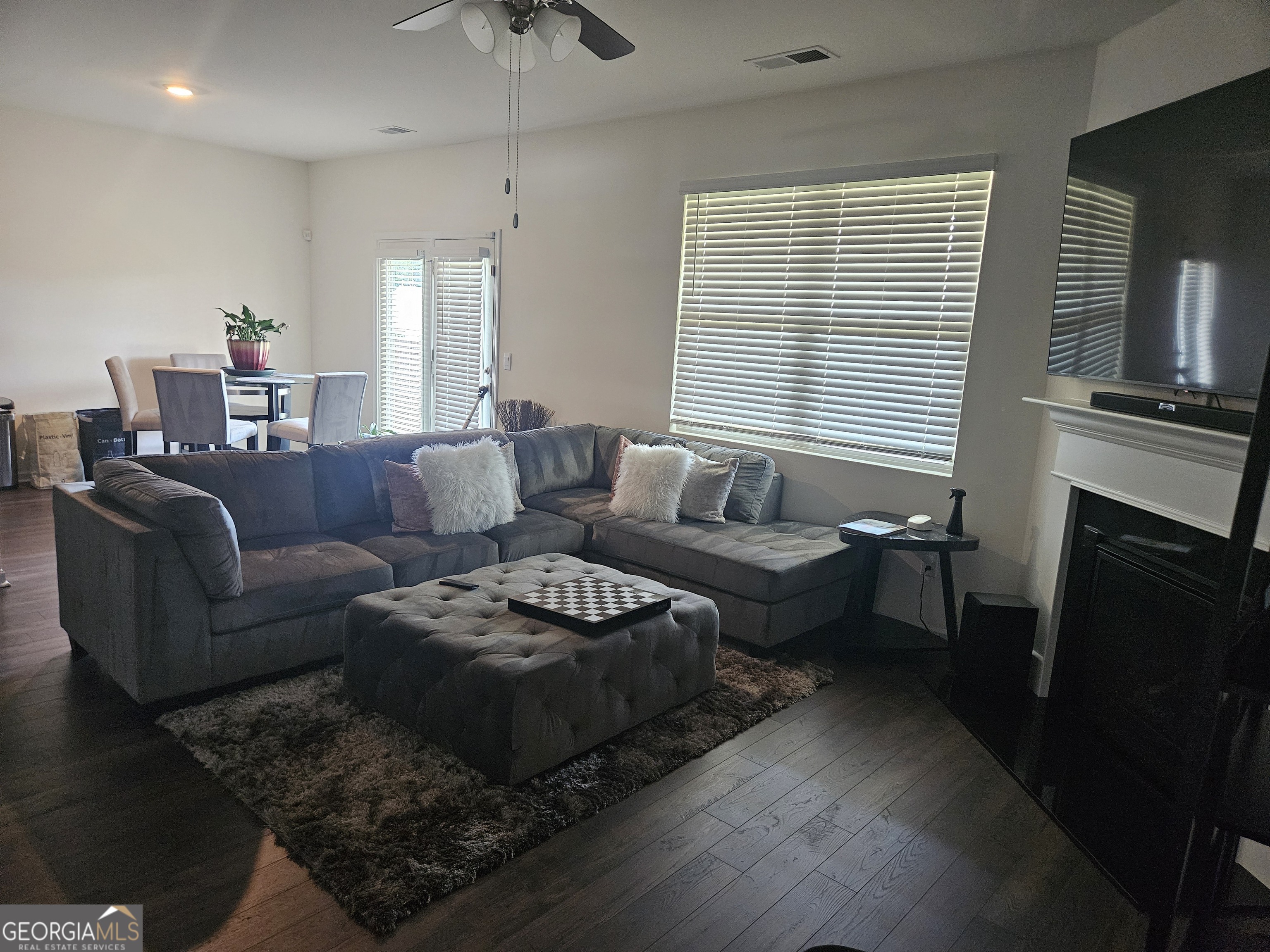 5454 Flat Rock Point Lithonia, GA 30038 - Photo 12 of 24 a living room with furniture wooden floor and a fireplace