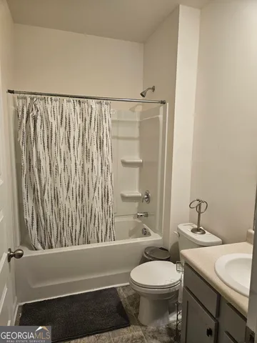 a bathroom with a toilet and a bathtub