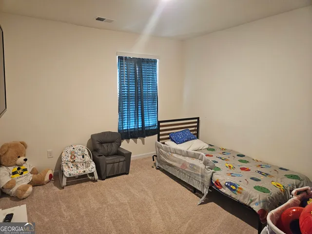 a bedroom with two beds and a window