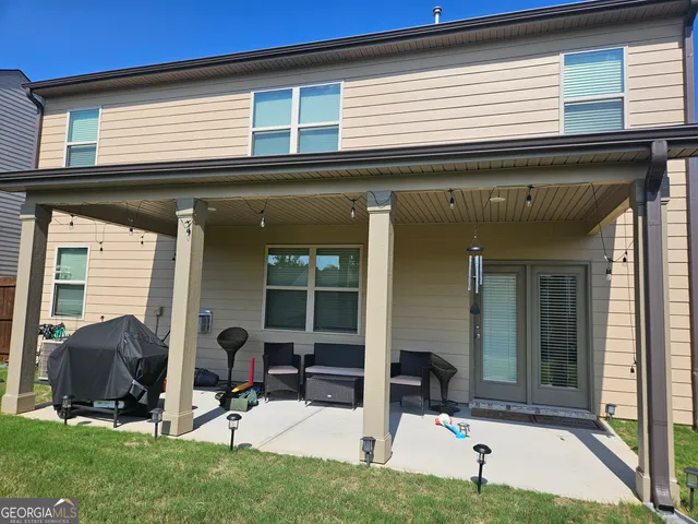 a view of a house with patio and yard