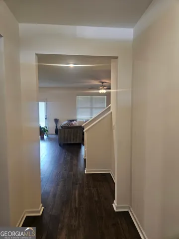 a view of a livingroom with wooden floor and a cabinet
