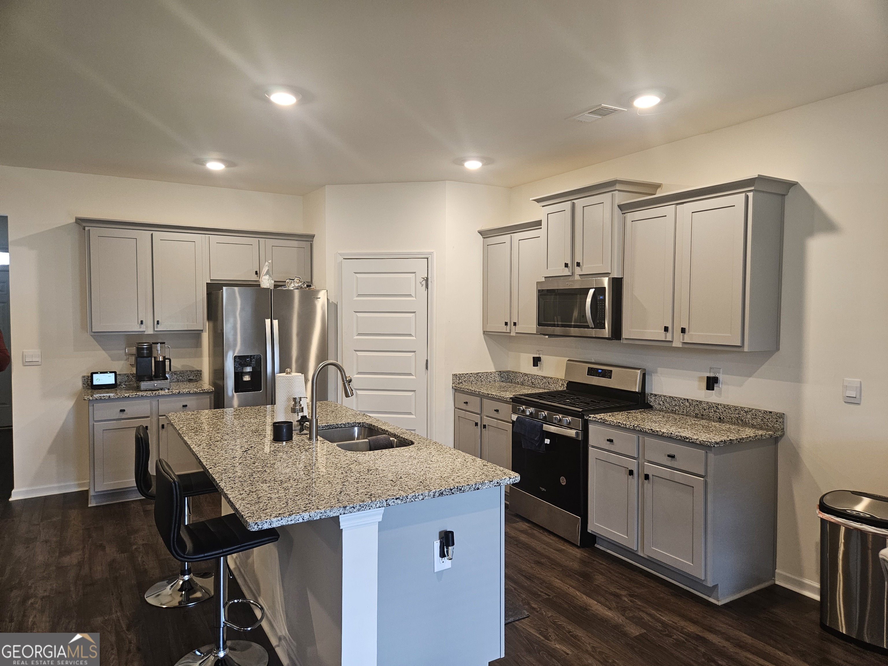 5454 Flat Rock Point Lithonia, GA 30038 - Photo 8 of 24 a kitchen with stainless steel appliances granite countertop a sink stove refrigerator and cabinets