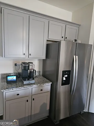 a kitchen with stainless steel appliances granite countertop a refrigerator sink and cabinets