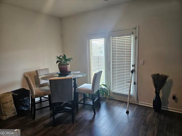 a dining room with furniture and wooden floor