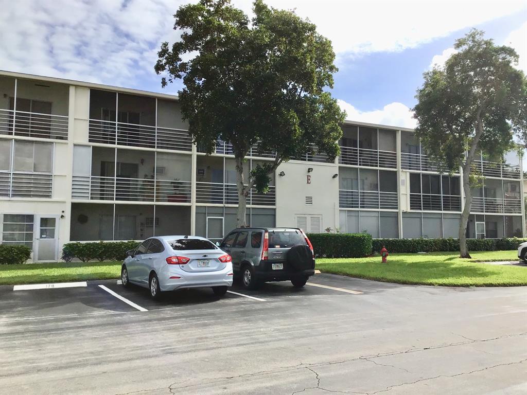 204 Preston Way, Unit 204 Boca Raton, FL 33434 - Photo 27 of 31 a car parked in front of a house and a yard