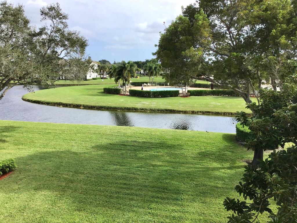 204 Preston Way, Unit 204 Boca Raton, FL 33434 - Photo 28 of 31 a view of a golf course with a lake view